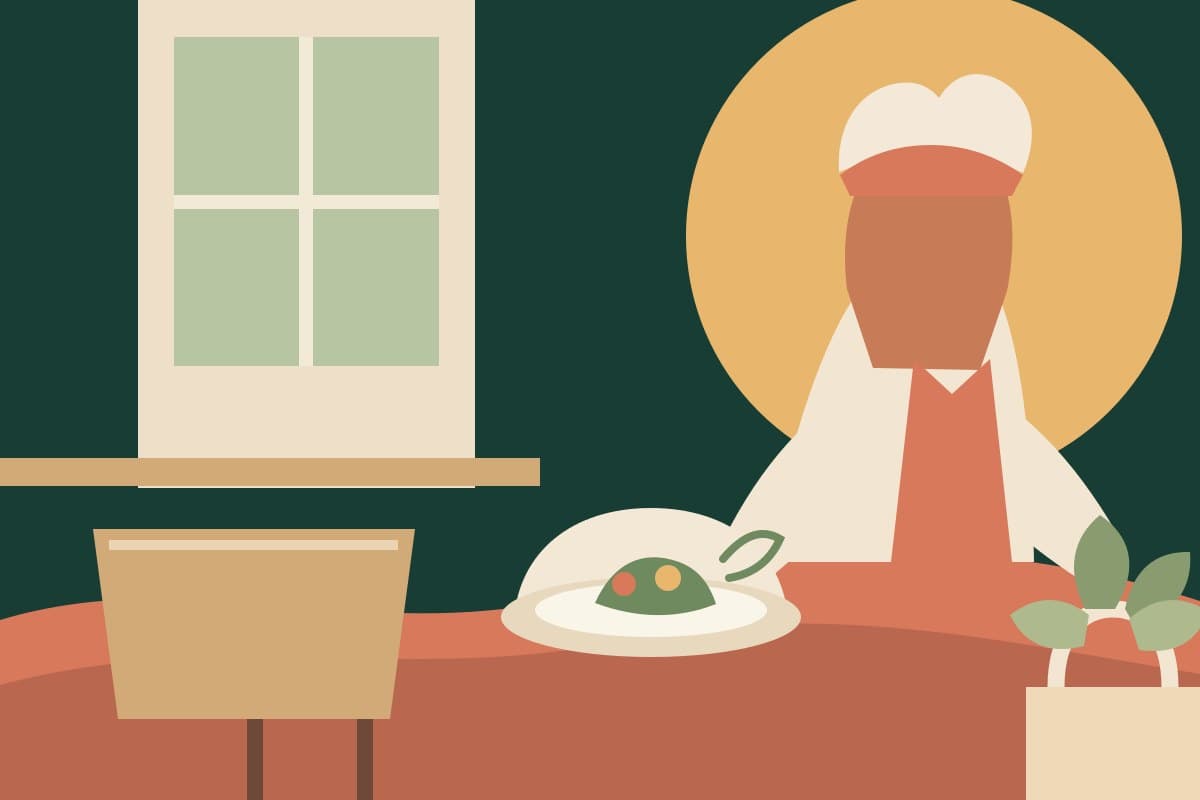 A chef carefully preparing a dish in a welcoming restaurant kitchen